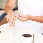 Image Of Female Hands Applying Cream